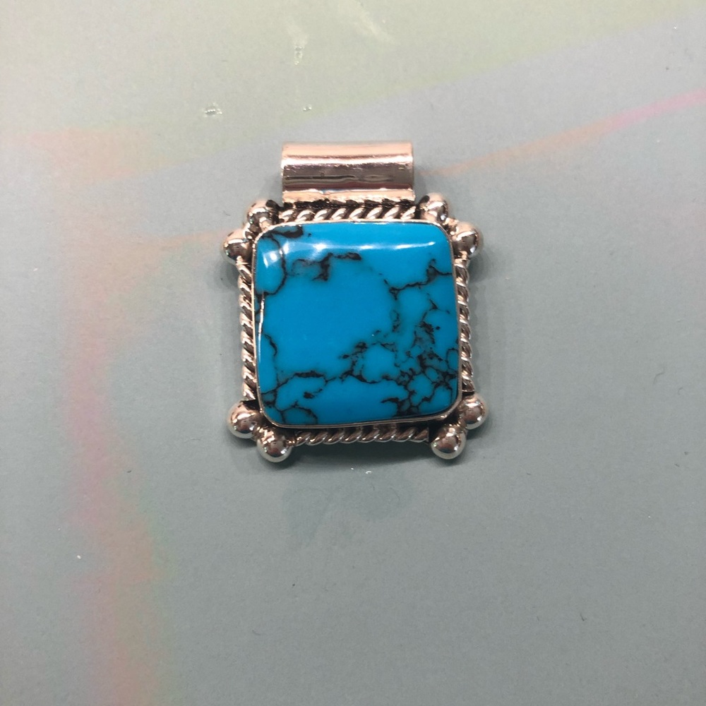 Turquoise and sterling silver pendant.
